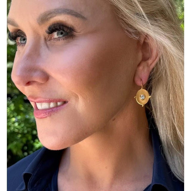 This pop of gold is great for any look. Accented with brilliant white topaz. Lightweight