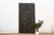 Standing nearly seven and a half feet tall, this vintage Nupe door from Nigeria is carved across four vertical planks with...