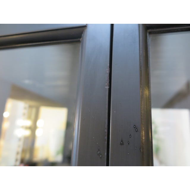 This elegant black lacquer vitrine is in the style of Joseph Hoffman. The cabinet doors open to large glass shelves and a...