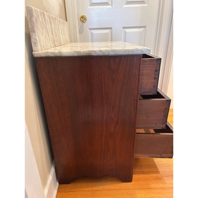 Small, three drawer mahogany chest of drawers or nightstand with marble top. This was part of a bedroom suite from the...