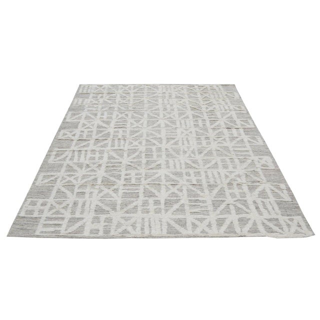 Hand-knotted with care using traditional rug-making techniques, this wool rug blends timeless craftsmanship with a modern...