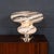 A striking italian table lamp dating to the 1970s, featuring a sculptural murano glass shade with bold white swirling...