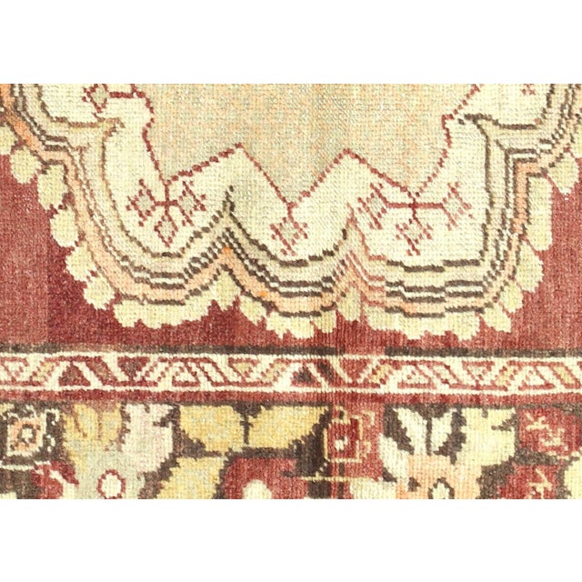Expertly handwoven in the Oushak region of Western Turkey, this Vintage Turkish Oushak Rug features a traditional design...