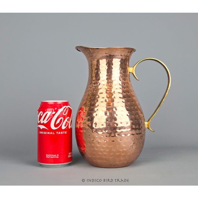 Vintage Hand Hammered Copper Pitcher with Brass Handle This lovely pitcher is made of hand-hammered copper with a...