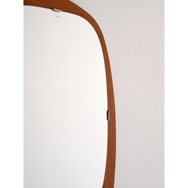 Scandinavian mirror from the 1960s with a free-form teak frame. Soft, asymmetrical lines typical of mid-century Nordic...