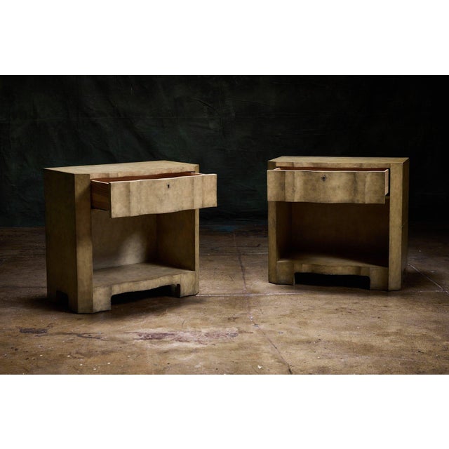 Pair of serpentine-front parchment nightstands, a matching set of 2 designer contemporary nightstands with one drawer and...