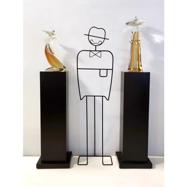 Made in Italy, 1960s - 1970s. These two sculptures are made in amber sommerso Murano glass and are quite heavy. These two...