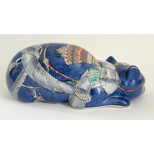 Offering a unique porcelain Chinese cat table sculpture, circa 1970s. This porcelain cat has a cobalt blue background with...