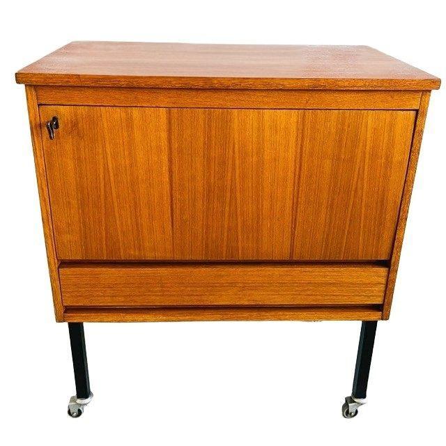 Danish design rolling bar cabinet in teak from the 1960s/70s, featuring black steel legs and wheels. Ideal as a bar...
