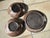 This set of two serving bowls and one serving plate from Serocka combines the workshop's signature warm earth tones, a...