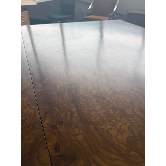 Vintage Dunbar olive burl dining table (Model D08) manufactured in Berne, Indiana. This elegant table features a richly...