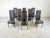 Set of 8 highback dining chairs with black lacquered wooden frames and leather seats and backrests. The back curves down...