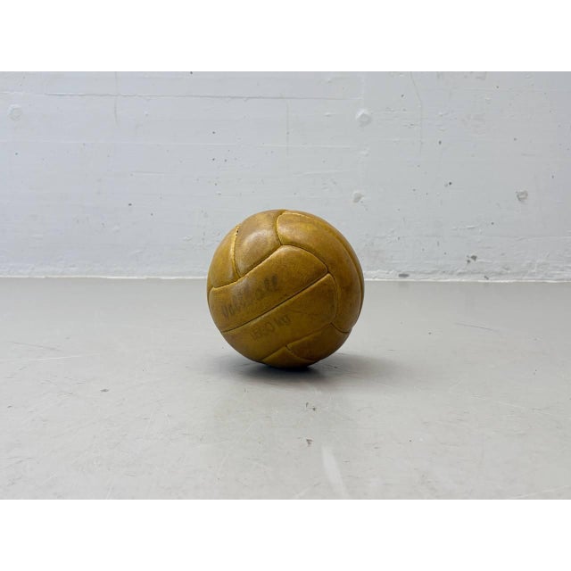 This original vintage leather ball impresses with its distinctive patina and classic, hand-stitched segmented...