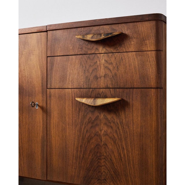 Restored Walnut Commode from Tatra Nabytok, 1950s, in Restored conditions. Designed 1950 to 1959 This piece has an...