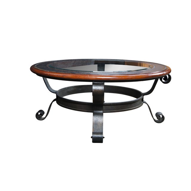 An equisite early 21st century Maitland Smith modern coffee table. Features a round top made from mahogany and engraved...