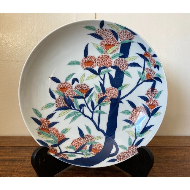 This vintage porcelain Imari shallow footed bowl or plate is in the style of Nabeshima. The design is that of a chestnut...