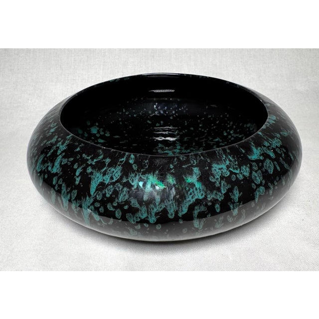 A mid to late 20th century sculptural art vessel consistent with a splatter ware design in turquoise paint with black...