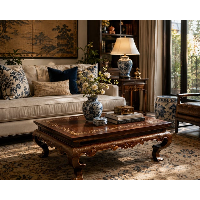 Richly detailed and visually striking, this vintage Baker Furniture coffee table features a luxurious oxblood-toned finish...