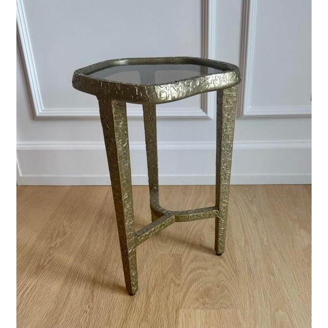 The Caracole Modern Edge “Contour” Side Table combines luxurious materials with an organic silhouette to create a...