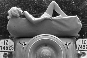 Peter Cornelius, Sunbathing on a Ford, 1938 / 2025, Photograph