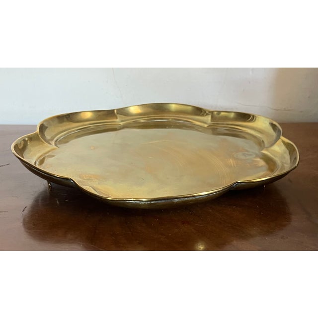 Antique 18th century English George III footed brass tray. Six petal shaped rim and rising on three applied feet. Measures...