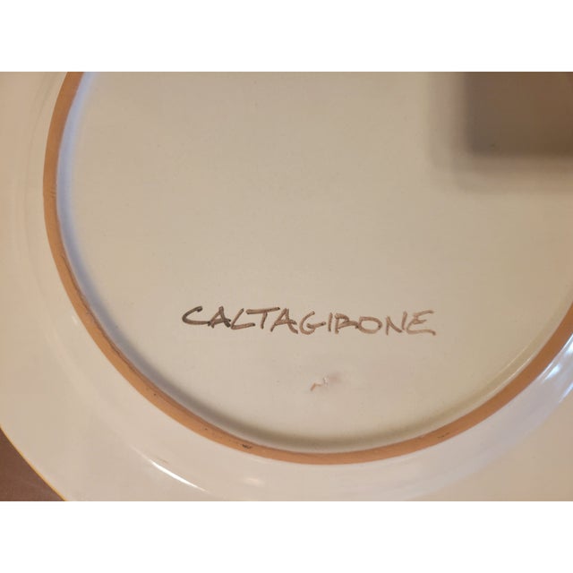 Ornamental plate of excellent workmanship, in fine Sicilian ceramic from Caltagirone. A central flower surrounded by...