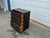 A striking vintage pine campaign chest featuring five full-width drawers and extensive iron hardware throughout. The chest...
