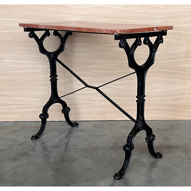 Antique cast iron French pastry style black scrolling "Butterfly" coffee table with marble top. Item features impressive...