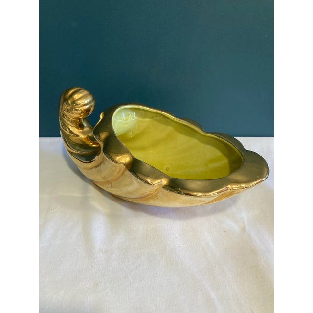 Very pretty gold shell planter or vase. Made of heavy ceramic that has been painted a beautiful gold. In excellent...