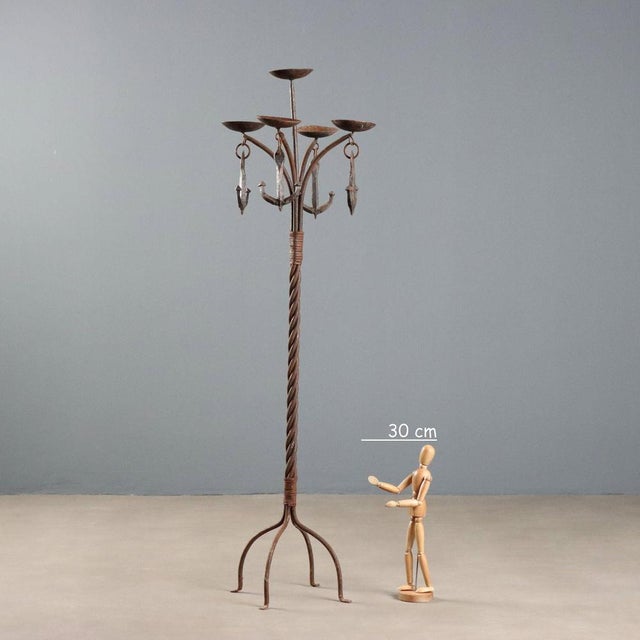Five-light candle holder with a torchon stand and four arched legs. Anchor decorations. This piece is attributed to the...