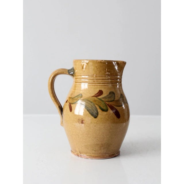 This is a stunning vintage Rockdale Union Stoneware pitcher. Crafted by potter Mark Connolly, the stoneware ewer features...