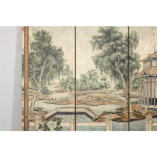 A four-panel folding screen depicting a serene Chinese garden landscape, this piece brings a sense of depth and...