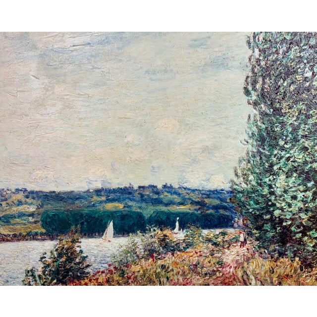 A striking oil on canvas reproduction after Alfred Sisley depicting The Seine at Bouille, a Gust of Wind (1894), also...