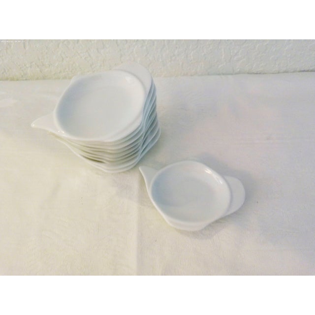 Charming set of ten white ceramic tea bag plates/spoon rests. Four are marked "Fitz & Floyd Everyday." No makers mark.