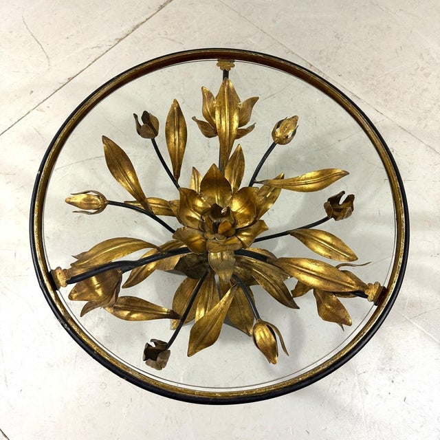 Lovely coffee / side table by Hans Kögl, Germany. Gilded brass bunch of flowers frame, glass table top. 1960’s. In good...