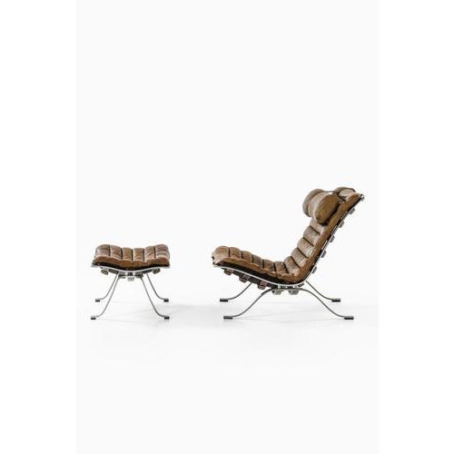 This rare easy chair with matching stool, model ari, designed by arne norell and produced by arne norell ab in aneby,...