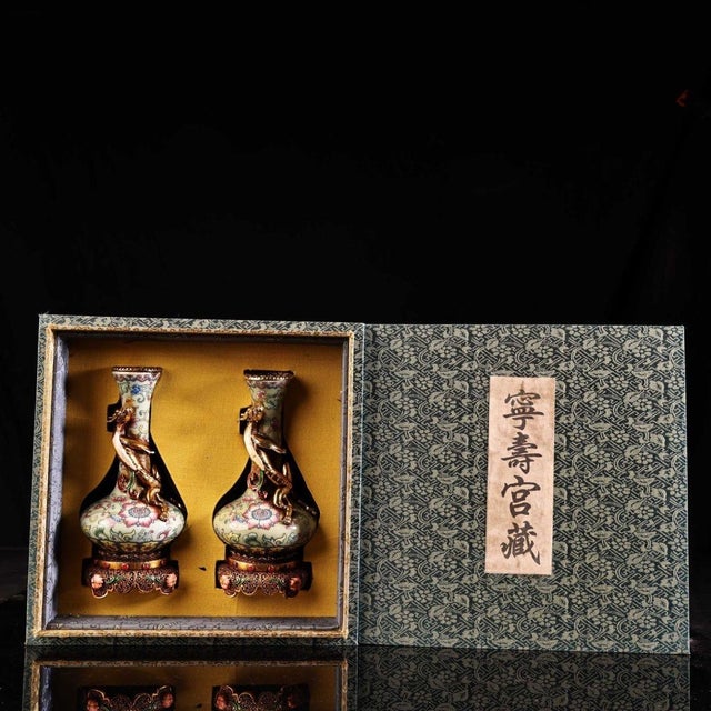Stunning matching pair of Chinese famille rose porcelain vases, hand-painted with vibrant scrolling floral and lotus...