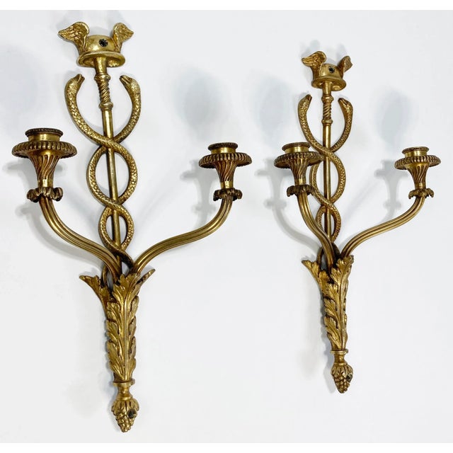 Beautiful vintage cast brass wall sconces featuring medical symbol of snakes climbing a winged staff. Ornate base. Each...