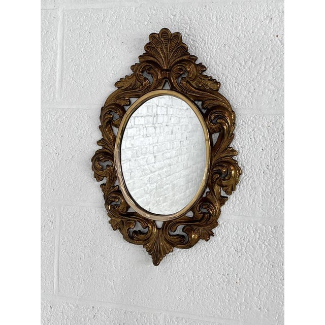Mirror gilded bronze regency and "rocaille", decorated with scrolls, shells and foliage