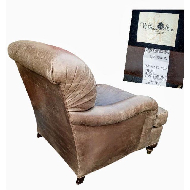 A Rare Vintage Genuine Leather Club Chair by William Alan and Ottoman Timeless Comfort: Sink into the rich history and...