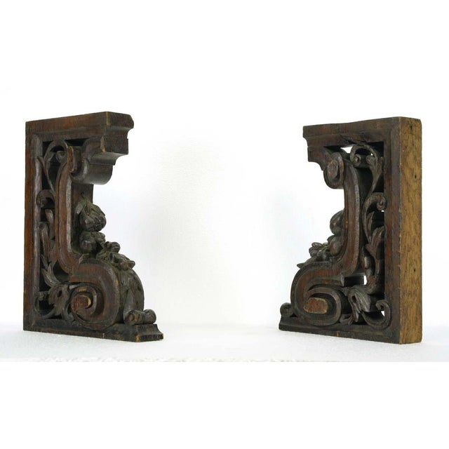 Dark tone solid oak hand carved decorative brackets. Good condition with appropriate wear from age, with one displaying a...
