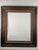 A substantial vintage Arts & Crafts style hand-carved wood picture frame, featuring a rich dark brown finish and...