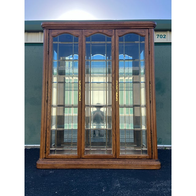 An immense single piece Oak display cabinet made by American of Martinsville. This display cabinet incorporates a mix of...