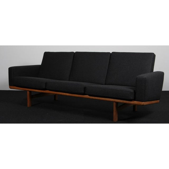 Hans J. Wegner three-seat sofa upholstered Camira wool. Frame in solid oak. Model 236/3, produced by GETAMA. This piece is...
