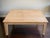 Made Goods “Tamsin” coffee table in solid teak featuring intricate hand-carved bone inlay across the top, apron, and legs....