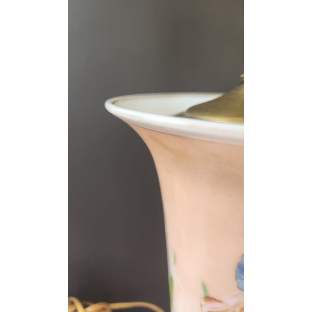 A charming mid-century vase-form table lamp in blush satin glass, hand-painted with a vivid blue iris and green stem...