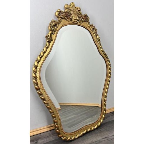 This Vintage French wall mirror features a beautifully shaped silhouette with elaborate carved detailing and a decorative...