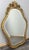 This Vintage French wall mirror features a beautifully shaped silhouette with elaborate carved detailing and a decorative...