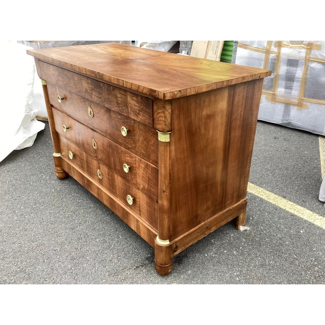 Very well-preserved Empire French Commode. Made of French walnut, this chest features 3 main drawers and one top drawer....