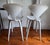 A pair of Norman Cherner's iconic 1958 molded plywood stools, produced under license by The Cherner Chair Company from the...